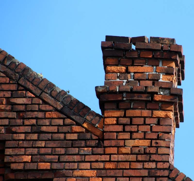 Damaged chimney on an Flat Rock home showing cracks and missing mortar